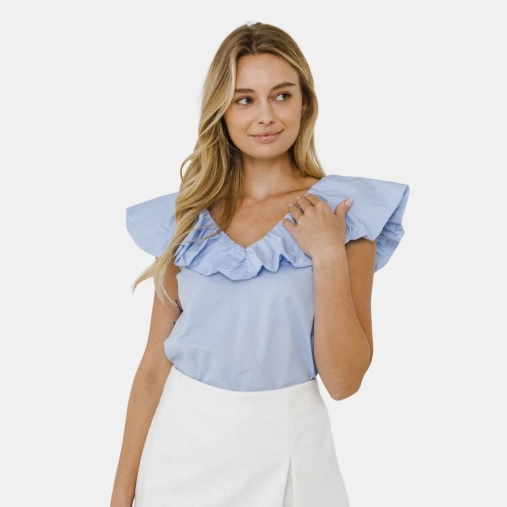 English Factory New With Tags light blue ruffle neck blouse. Retail $68 XS